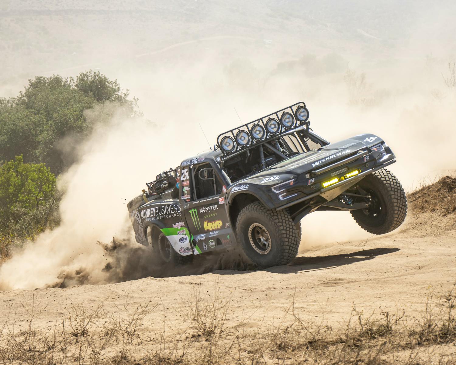 Offroad Racing Car Driving on a Dirt Road in a Cloud of Dust