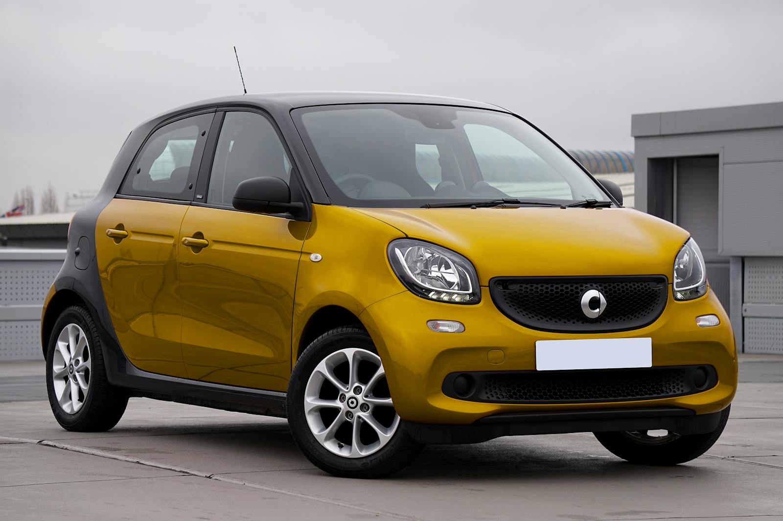 A Yellow Smart Forfour on a Parking Lot