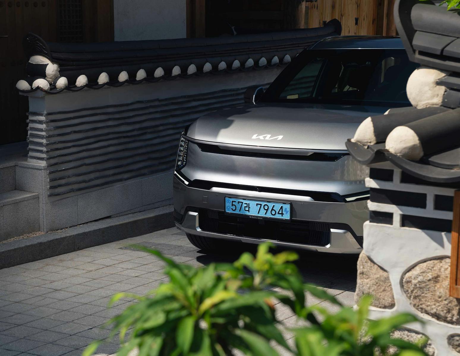 The Kia EV9 parked in a traditional Korean village.