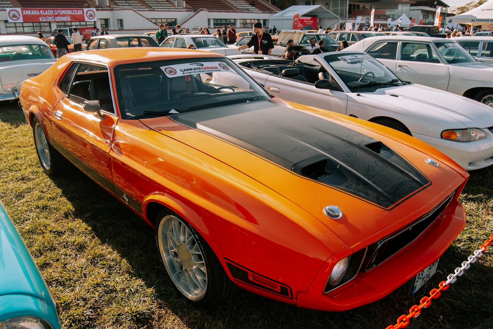 First Generation Ford Mustang Mach 1 with Lettering on the Dusty Hood at Car Show